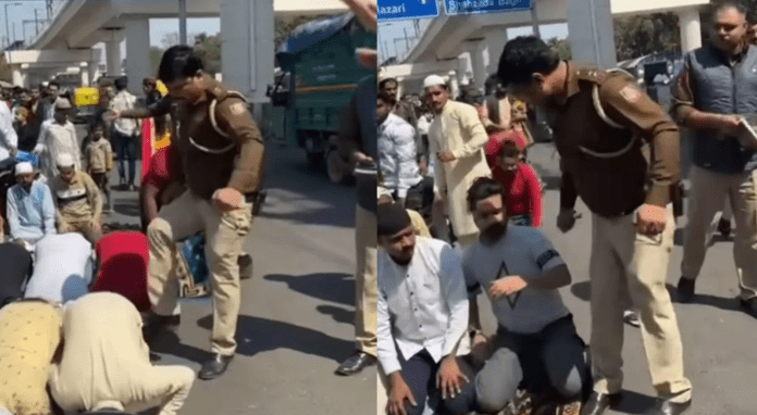Screenshot of Video Captures Delhi Police Officer Kicking Muslim Men in Prayer on Road (X)